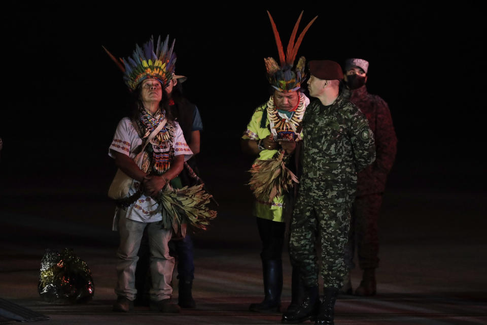 FILE - Military personnel and Indigenous leaders stand on the tarmac during the arrival of four Indigenous children who were missing for 40 days after a deadly plane crash, at the military air base in Bogota, Colombia, June 10, 2023. Indigenous men who were among search teams hoping to find the children aboard a plane that crashed in the Amazon jungle say one of their most sacred rituals played a role in rescue efforts. (AP Photo/Ivan Valencia, File)