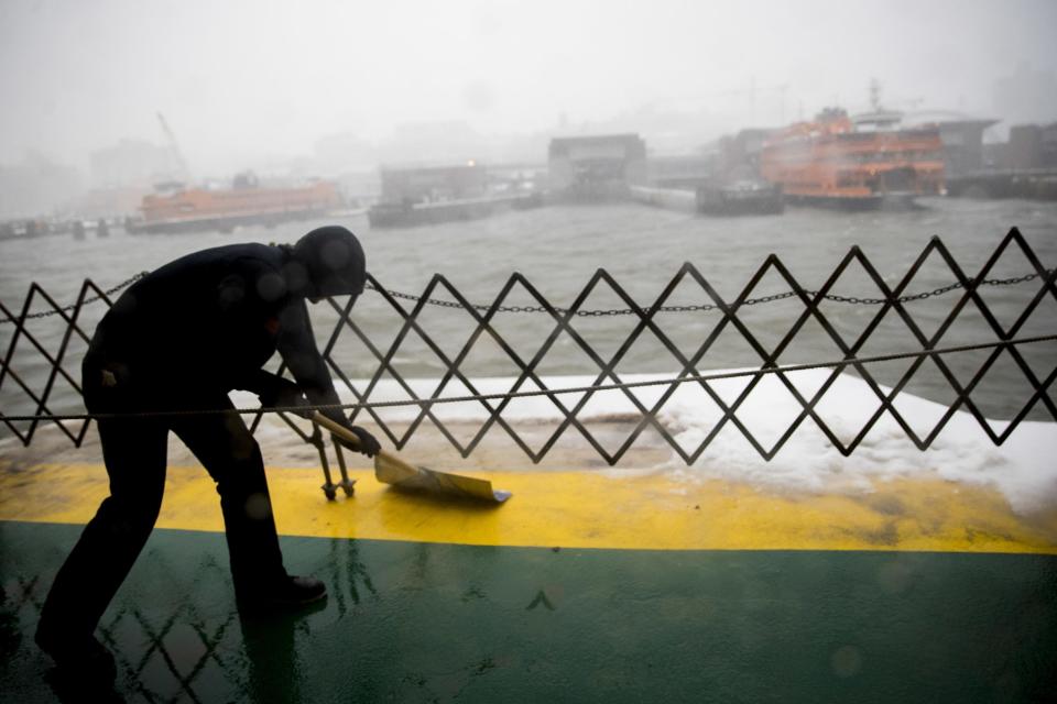 A member of the Staten Island ferry crew clears the deck as the ferry approaches the terminal during a snowstorm, Tuesday, March 14, 2017, in New York. (AP Photo/Mary Altaffer)