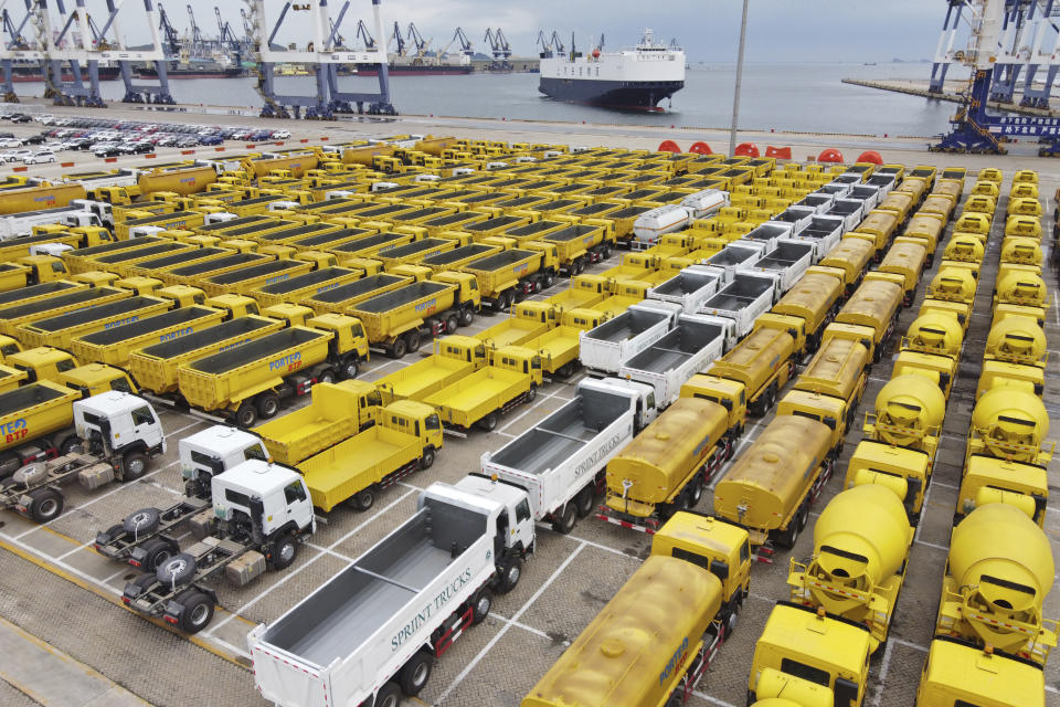 Trucks for export wait to be transported at a sea port in Yantai in eastern China's Shandong province Friday, July 30, 2021. China's manufacturing growth in July slowed to its lowest level in 15 months as export demand weakened and factories coped with disruptions in supplies of raw materials and components, two surveys found. (Chinatopix via AP)