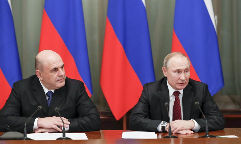 Russian President Vladimir Putin, right, and new Russian Prime Minister Mikhail Mishustin attend a new cabinet meeting in Moscow, Russia, Tuesday, Jan. 21, 2020. Putin formed his new Cabinet Tuesday, replacing many of its members but keeping his foreign, defense and finance ministers in place. (Dmitry Astakhov, Sputnik, Government Pool Photo via AP)