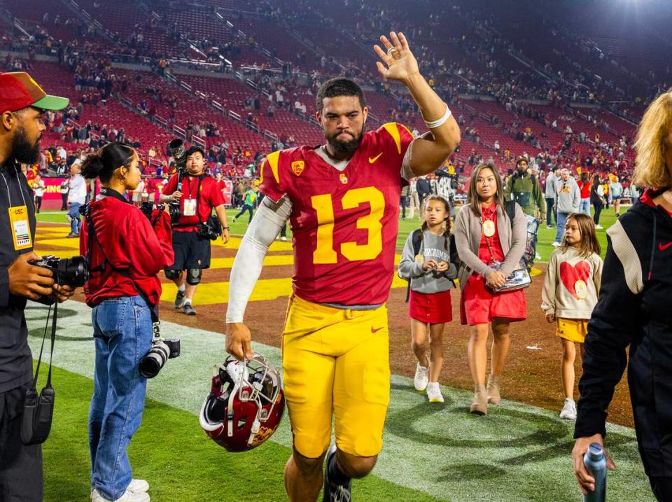 USC Trojans quarterback Caleb Williams (13) waves to fans while leaving the field after the Trojans’ 52-42 loss to Washington at Los Angeles Memorial Coliseum Nov. 4, 2023, in Los Angeles.