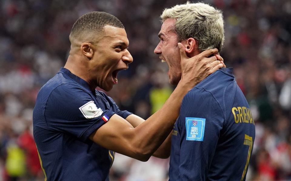 France's Kylian Mbappe and Antoine Griezmann celebrates their sides second goal scored by Olivier Giroud during the FIFA World Cup Quarter-Final match at the Al Bayt Stadium in Al Khor, Qatar - PA