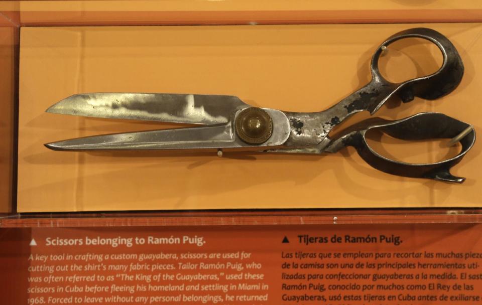 In this Wednesday, Oct. 17, 2012 photo, sewing scissors that belonged to well-known guayabera tailor Ramon Puig are on display at an exhibition titled "The Guayabera: A Shirt's Story" at the Museum of History Miami, in Miami. This is the first exhibition to trace the story of the shirt's evolution through Cuba, Mexico, and the United States. (AP Photo/Lynne Sladky)