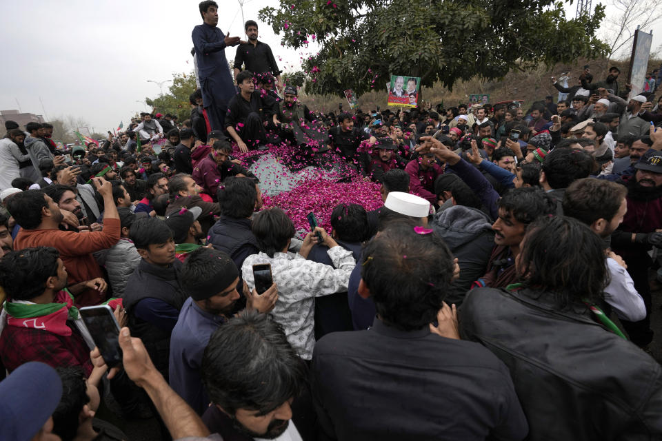 Security personnel clear way for a vehicle carrying former Pakistani Prime Minister Imran Khan after his court appearance, in Islamabad, Pakistan, Tuesday, Feb. 28, 2023. A Pakistani court approved bail for Khan after he appeared before a judge in Islamabad amid tight security, officials said, months after police filed terrorism charges against the country's popular opposition leader for inciting people to violence. (AP Photo/Anjum Naveed)