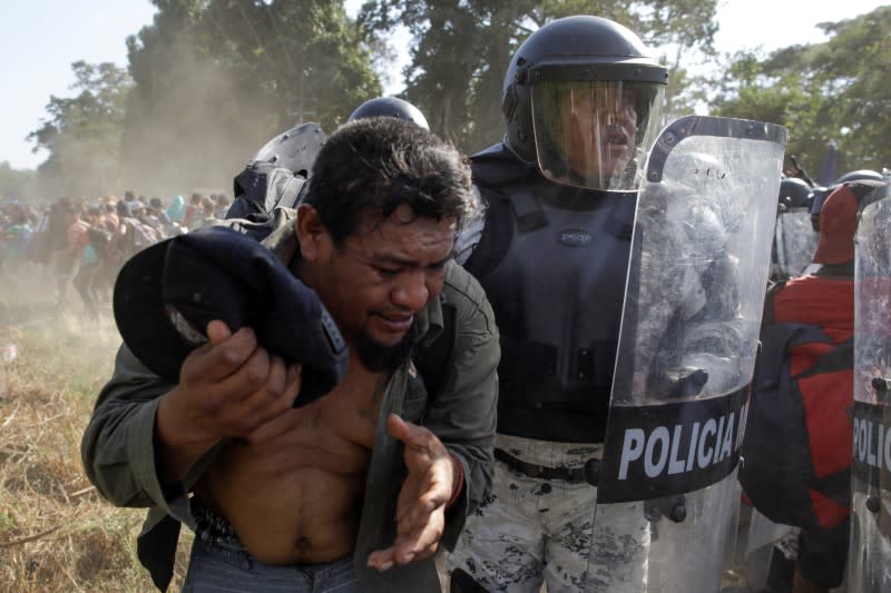 Migrants, mainly from Central America and marching in a caravan, scuffle with security forces, near Frontera Hidalgo, Chiapas