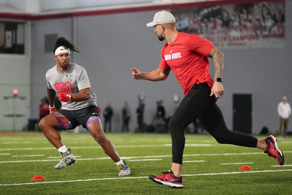 Mar 20, 2024; Columbus, Ohio, USA; Ohio State Buckeyes linebacker Steele Chambers works out with James Laurinaitis during Pro Day at the Woody Hayes Athletic Center.