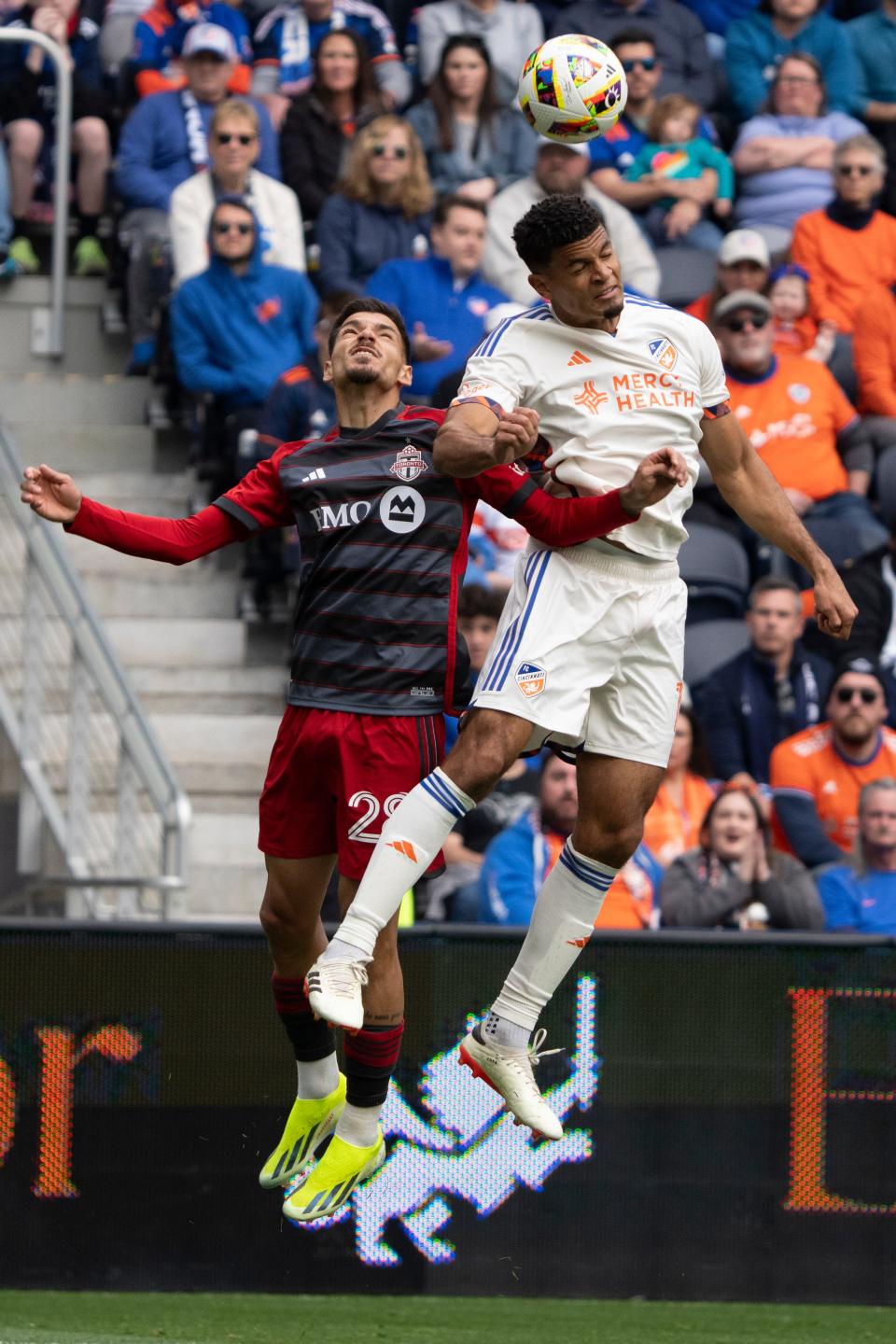 Defender Miles Robinson (12) heads the ball in the first half of Sunday's draw with Toronto FC. Robinson was among the newcomers making their MLS debut for FC Cincinnati.