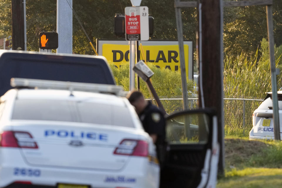 Law enforcement officers investigate the scene of a mass shooting at a Dollar General store Saturday, Aug. 26, 2023, in Jacksonville, Fla. (AP Photo/John Raoux)