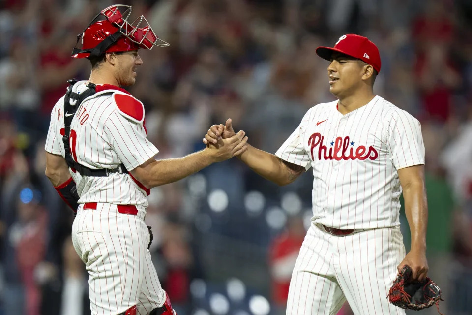 Philadelphia Phillies starting pitcher Ranger Suarez, right, celebrates the win with catcher J.T. Realmuto, left, following the baseball game against the Colorado Rockies, Tuesday, April 16, 2024, in Philadelphia. The Phillies won 5-0. (AP Photo/Chris Szagola)