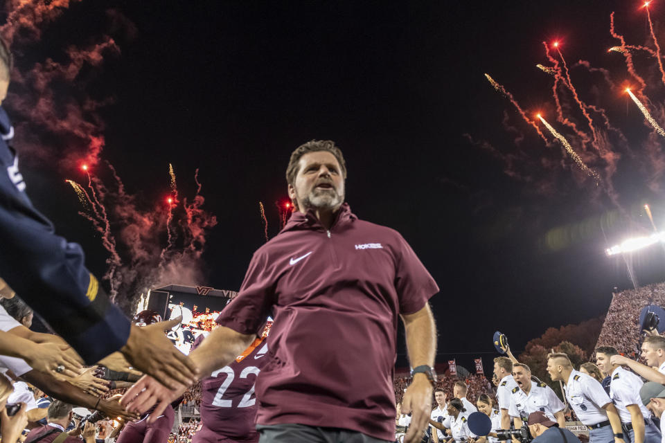 Virginia Tech coach Brent Pry heads onto the field before the team's NCAA college football game against Syracuse on Thursday, Oct. 26, 2023, in Blacksburg, Va. (AP Photo/Robert Simmons)
