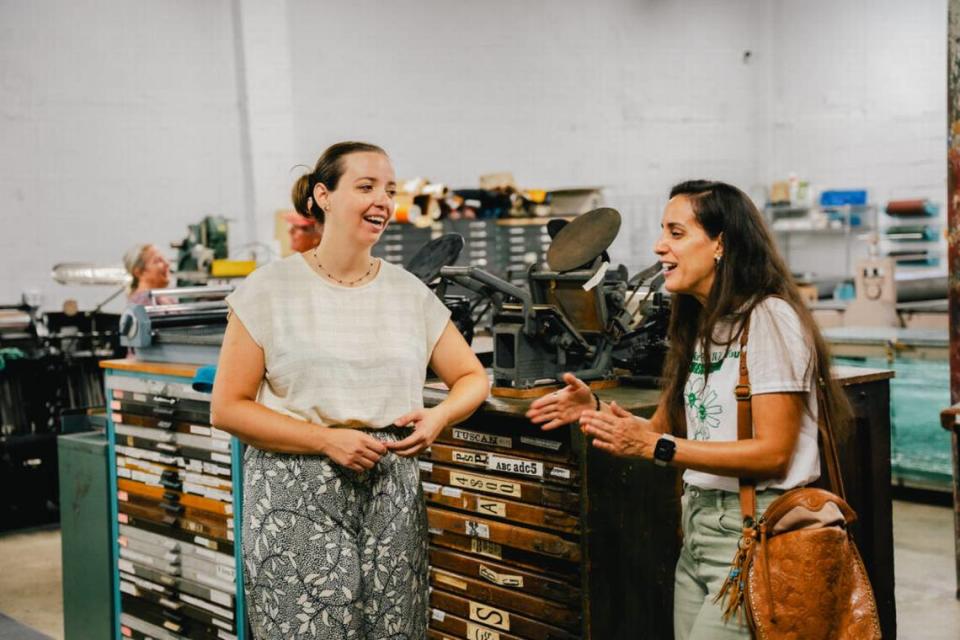 Ingrid Schindall and Amanda Linares next to type cabinets at IS Projects.