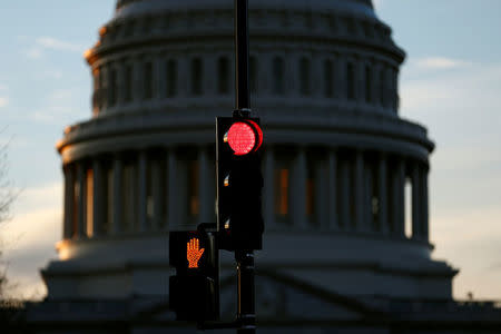 A traffic light shines red after President Donald Trump and the U.S. Congress failed to reach a deal on funding for federal agencies in Washington, U.S., January 20, 2018. REUTERS/Joshua Roberts