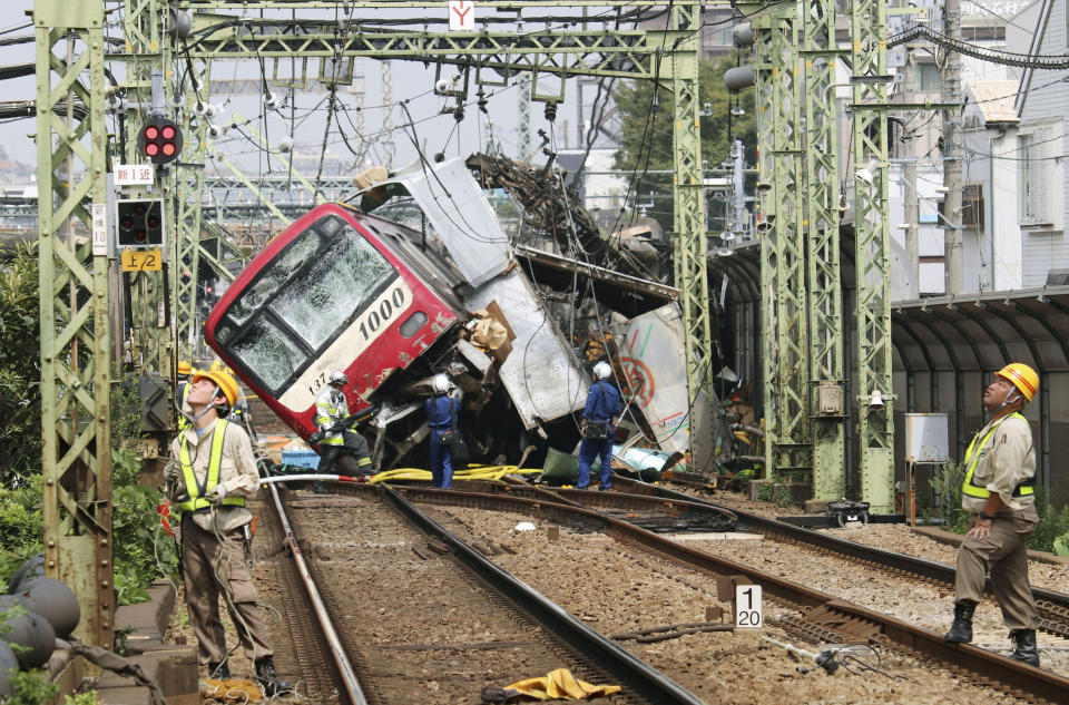 A train sits derailed after a collision with a truck in Yokohama, near Tokyo Thursday, Sept. 5, 2019. Police and fire department officials said the collision occurred late morning Thursday as the truck apparently entered a railway crossing in Yokohama. (Kyodo News via AP)