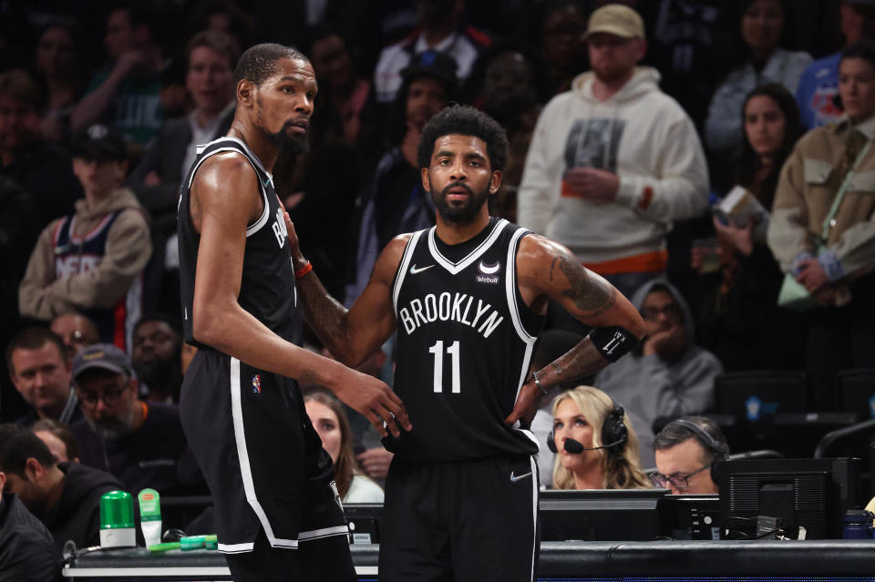 NEW YORK, NEW YORK - APRIL 23:  Kevin Durant #7 and Kyrie Irving #11 of the Brooklyn Nets look on in the final seconds of their 109-103 loss against the Boston Celtics during Game Three of the Eastern Conference First Round NBA Playoffs at Barclays Center on April 23, 2022 in New York City.  NOTE TO USER: User expressly acknowledges and agrees that, by downloading and or using this photograph, User is consenting to the terms and conditions of the Getty Images License Agreement.  (Photo by Al Bello/Getty Images).