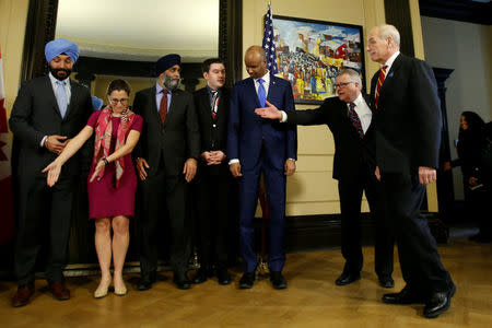 U.S. Homeland Security Secretary John Kelly (R) arrives for a group photo with Canada's Public Safety Minister Ralph Goodale (2nd R) on Parliament Hill in Ottawa, Ontario, Canada, March 10, 2017. Also pictured are Innovation, Science and Economic Development Minister Navdeep Bains (L), Foreign Minister Chrystia Freeland (2nd L), Defence Minister Harjit Sajjan (3rd L), Parliamentary Secretary to the Minister of Fisheries Terry Beech (C) and Immigration Minister Ahmed Hussen (3rd R). REUTERS/Chris Wattie