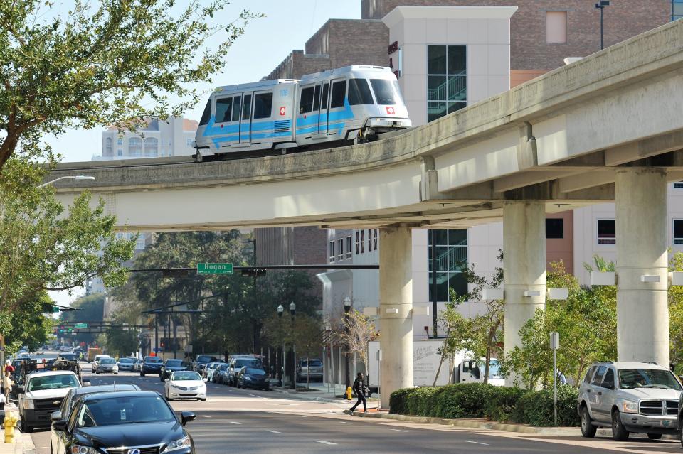 One of the Skyway vehicles in the new color scheme makes the turn from Hogan Street to West Bay Street Thursday, November 17. 2016. (Bob Self/Florida Times-Union)