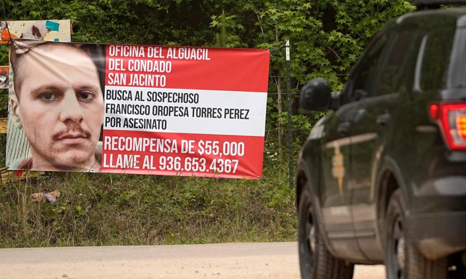 A state trooper vehicle passes a posted wanted sign for a mass shooting suspect Tuesday, May 2, 2023, in the neighborhood where the shooting occurred Friday, in Cleveland, Texas. (AP)