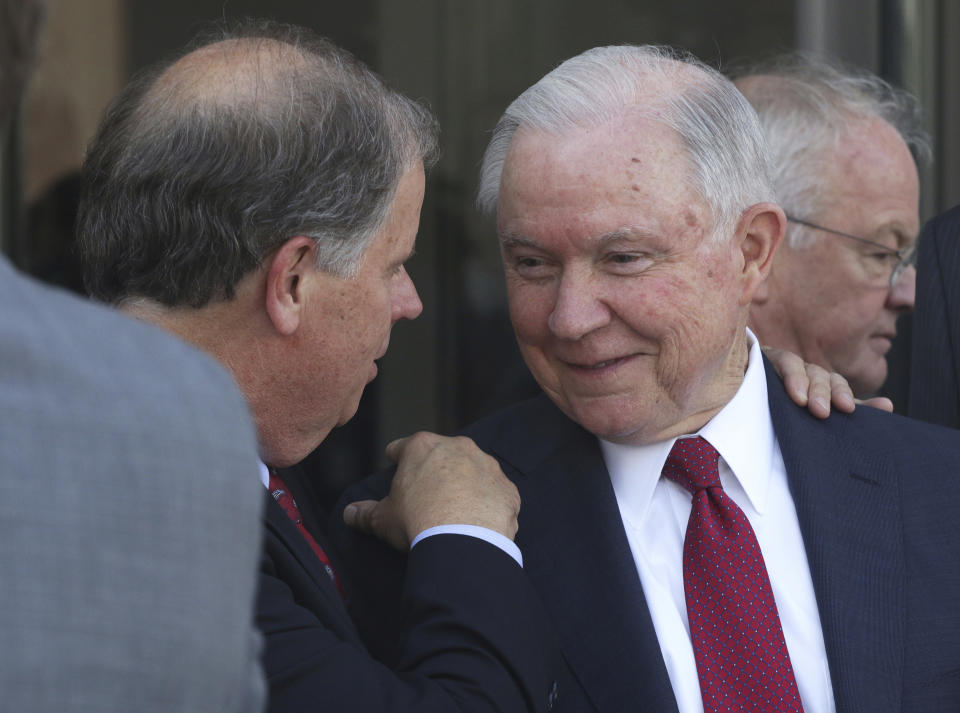 U.S. Sen. Doug Jones, D-Ala., speaks with Attorney General Jeff Sessions during the dedication for the United States Courthouse for the Southern District of Alabama in Mobile, Ala. on Sept. 7, 2018. (AP Photo/Dan Anderson)