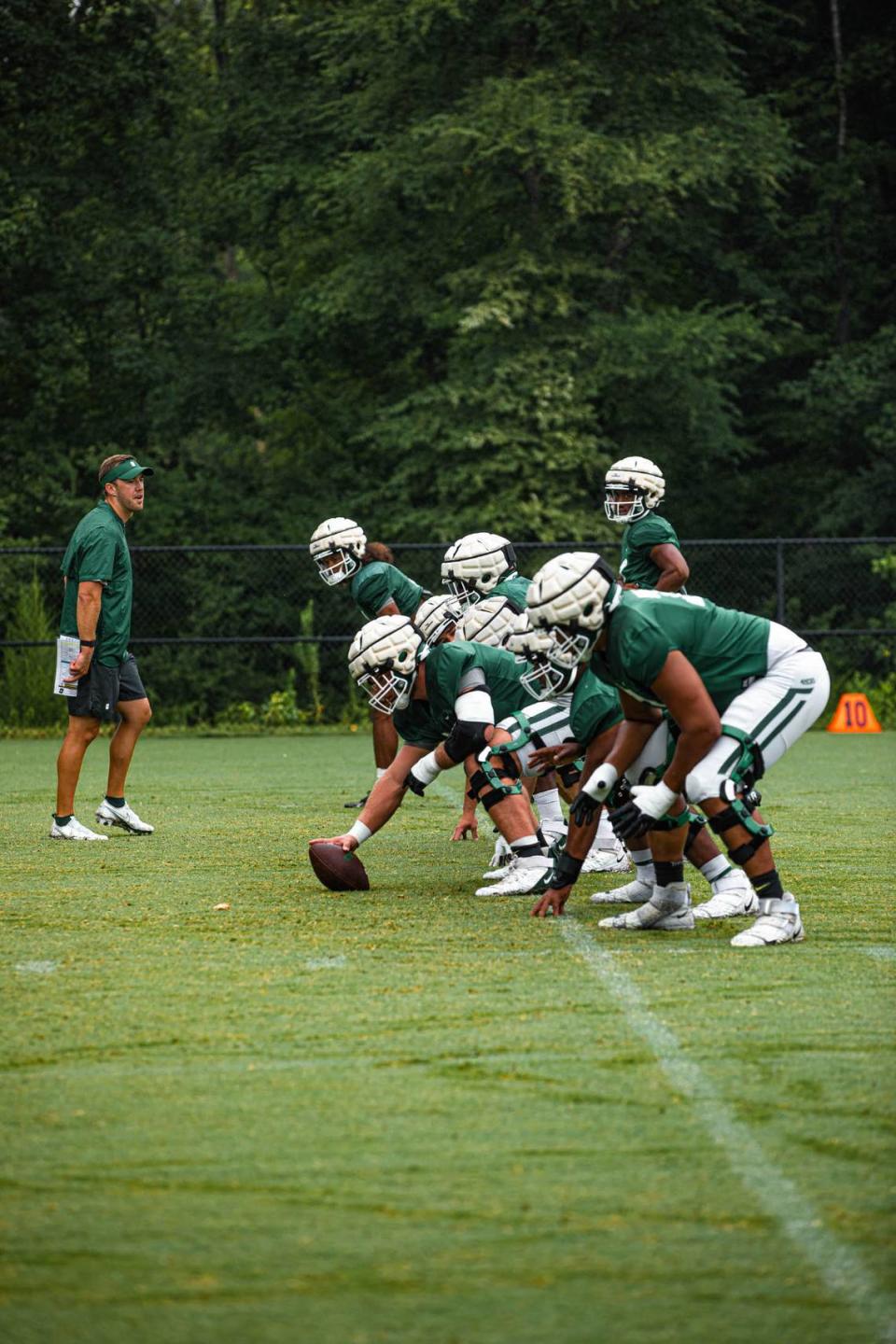 The Charlotte 49ers offensive line gets set to run a play during preseason workouts recently. Charlotte 49ers Athletics/Charlotte 49ers Athletics