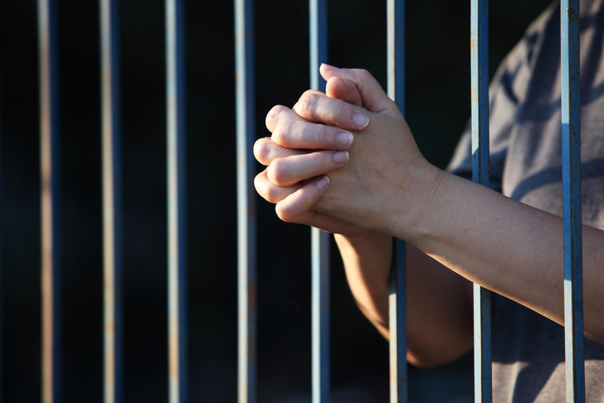 Hands praying in jail (Getty Images)