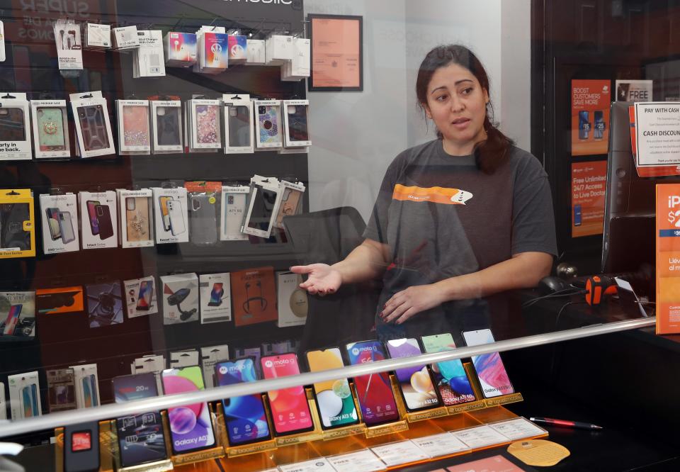 Vanessa Hernandez talks about the revitalization plan for the village of Brewster, while in the Boost Mobile store on Main Street in the village of Brewster May 5, 2022. 