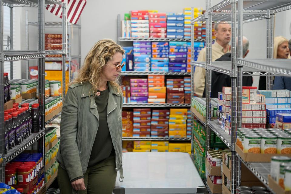 Lizzett Cuervo, a vice-president of the board of the FCDC, looks through the food pantry. The grand re-opening and ribbon cutting ceremony for the Franciscan Community Development Center of Fairview Food Pantry in Fairview, NJ on Wednesday April 26, 2023. The food pantry serves nearly 800 families and 4000 individuals each month. 