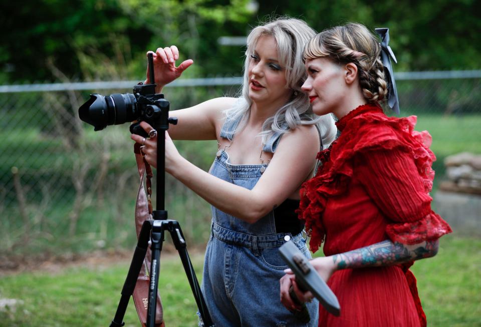 Heidi Mae Herrington (left), 34, and AJ Jenkins, 30, check the setup of their camera as they recreate a movie poster for the slasher-horror film "Pearl" on Thursday, May 4, 2023.