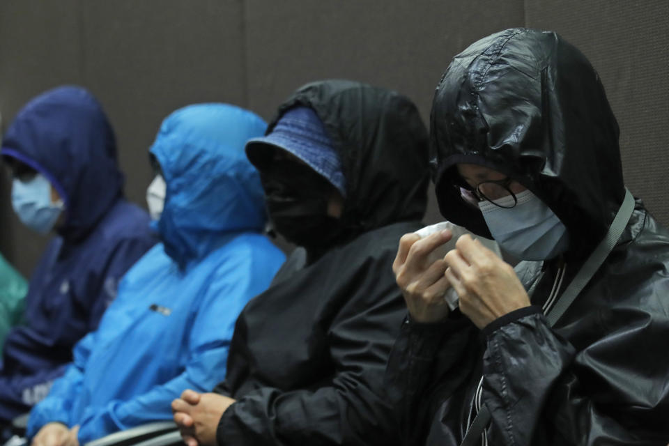 Relatives of 12 Hong Kong activists detained at sea by Chinese authorities attend a press conference in Hong Kong, Saturday, Sept. 12, 2020. They called for their family members to be returned to the territory, saying their legal rights were being violated. (AP Photo/Kin Cheung)