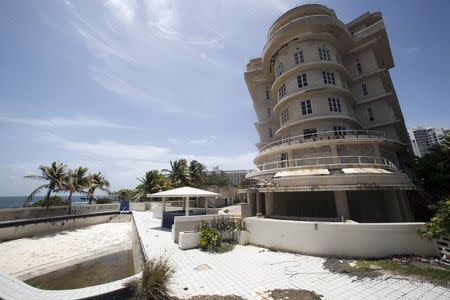 A view of the empty swimming pool and the outside of the luxury Normandie Hotel, closed since 2008, in San Juan, Puerto Rico, July 18, 2015. Puerto Rico may sport palm trees, pristine beaches and glorious weather but its tourism industry is losing out to rival Caribbean islands - and that is holding the U.S. territory back at a time when its deeply troubled economy most needs a fillip. REUTERS/Alvin Baez