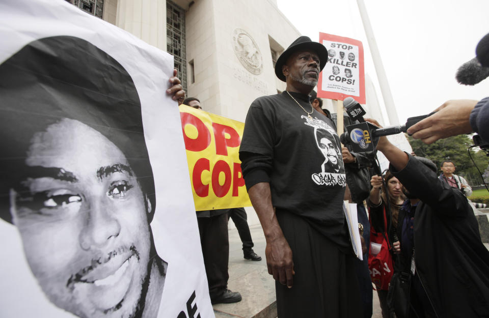 FILE - In this June 13, 2011, file photo, Cephus "Bobby" Johnson stands on the steps of the U.S. District Court building in Los Angeles protesting the release of Johannes Mehserle, the former San Francisco Bay area transit officer who fatally shot Johnson's nephew Oscar Grant. A Northern California prosecutor announced Monday, Oct. 5, 2020, that she will reopen the investigation into the killing of Grant at a train station by a police officer 11 years earlier. Grant, 22, was fatally shot in the back by Bay Area Rapid Transit Officer Johannes Mehserle while he was on the floor of a train station on New Year's Day in 2009. (AP Photo/Nick Ut, File)