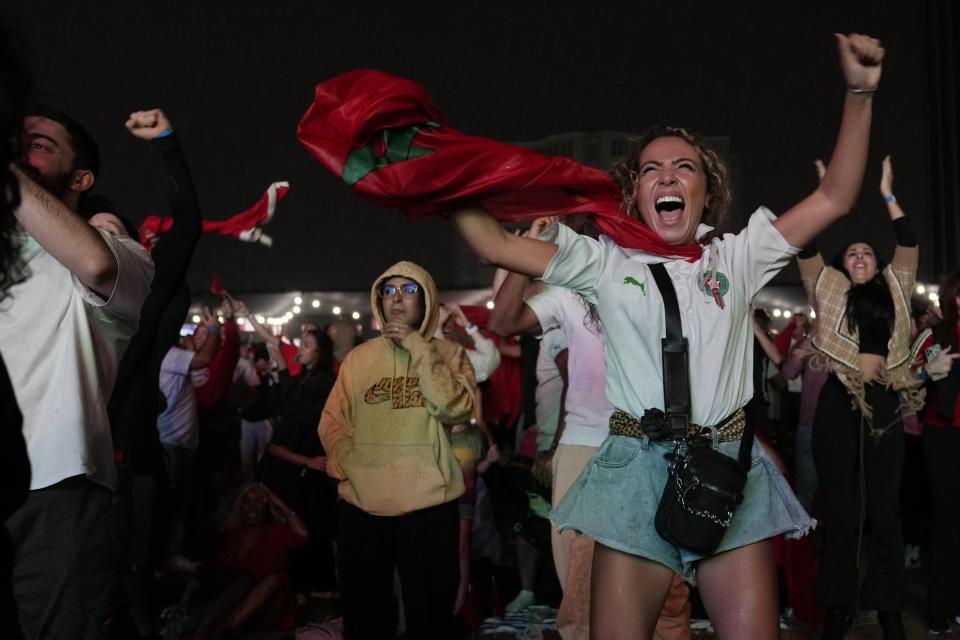 FILE - Moroccan fans celebrate after their team scored the first goal during a World Cup quarter-final soccer match between Portugal and Morocco, at the Dubai Media City, in Dubai, United Arab Emirates, Saturday, Dec. 10, 2022. It's a rare moment in the Middle East when the public's voice roars louder than those of the governments. But Morocco's surprise wins at the World Cup have stirred a joy and pride among many Arab fans that have, at least for a moment, eclipsed the region's many political divisions. (AP Photo/Kamran Jebreili, File)