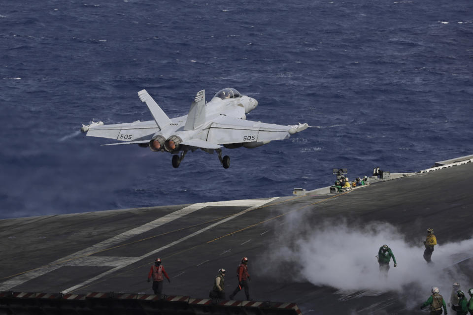 An F/A-18 Super Hornet fighter jet takes off on the deck of the U.S. Navy USS Ronald Reagan in the South China Sea, Tuesday, Nov. 20, 2018. China is allowing a U.S. Navy aircraft carrier and its battle group to make a port call in Hong Kong after it turned down similar request amid tensions with Washington. (AP Photo/Kin Cheung)