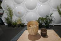 A container of compost produced from human remains is shown at right, next to a container of straw and other material used in the process, which takes place in the array of vessels in the background at Recompose, a company that composts human remains into soil, Wednesday, Sept. 15, 2021, in Kent, Wash., south of Seattle. Earlier in September, Colorado became the second state after Washington to allow human body composting, and Oregon will allow the practice beginning next July. (AP Photo/Ted S. Warren)