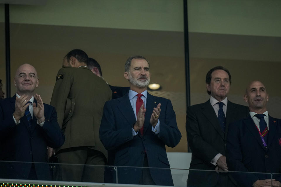 Spain's King Felipe VI, center, applauds next to FIFA President Gianni Infantino, left, and President of the Spanish Football Federation Luis Rubiales, right, during the World Cup group E soccer match between Spain and Costa Rica, at the Al Thumama Stadium in Doha, Qatar, Wednesday, Nov. 23, 2022. (AP Photo/Francisco Seco)