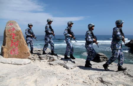 Soldiers of China's People's Liberation Army (PLA) Navy patrol at Woody Island, in the Paracel Archipelago, which is known in China as the Xisha Islands, January 29, 2016. REUTERS/Stringer