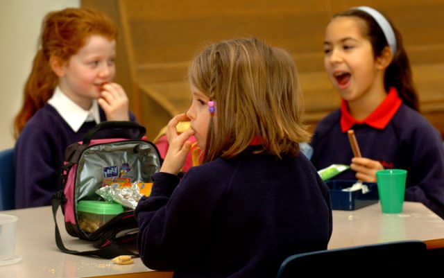 Pupils eating their packed lunches at school