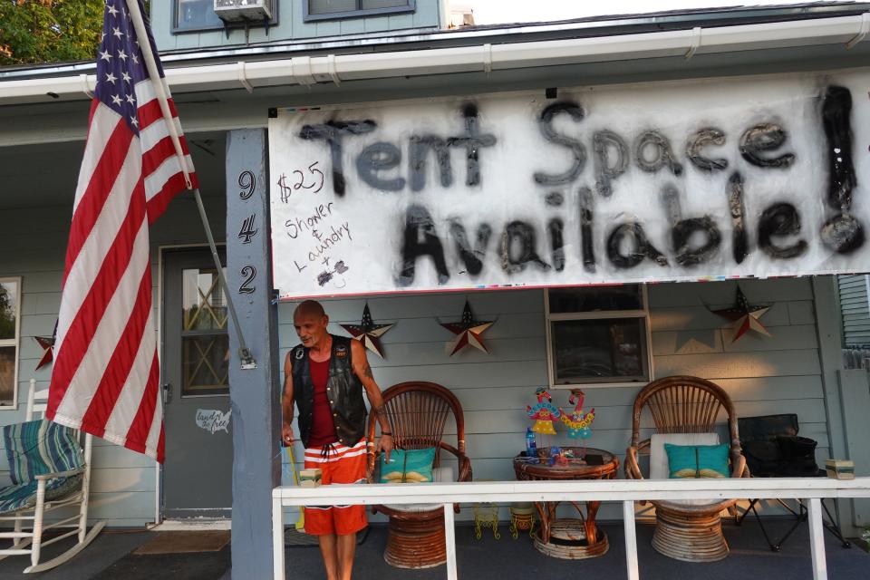 Mike Geyer stands on the porch of his home where he rents spaces in his front and back yard to campers attending the 81st annual Sturgis Motorcycle Rally on August 08, 2021 in Sturgis, South Dakota.