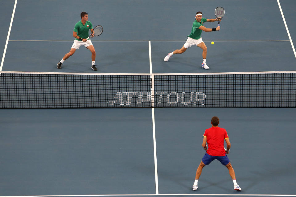 Grigor Dimitrov and Alexandar Lazarov of Bulgaria play a shot in their doubles game against Radu Albot and Alexander Cozbinov of Moldova during their ATP Cup tennis match in Sydney, Sunday, Jan. 5, 2020. (AP Photo/Steve Christo)