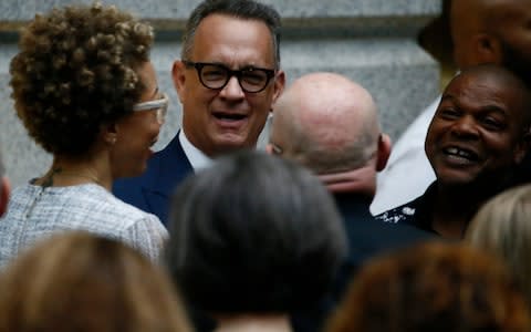 Artists Sherald and Wiley gather with Hanks prior to unveiling of Obamas' portraits at the Smithsonian - Credit: Reuters