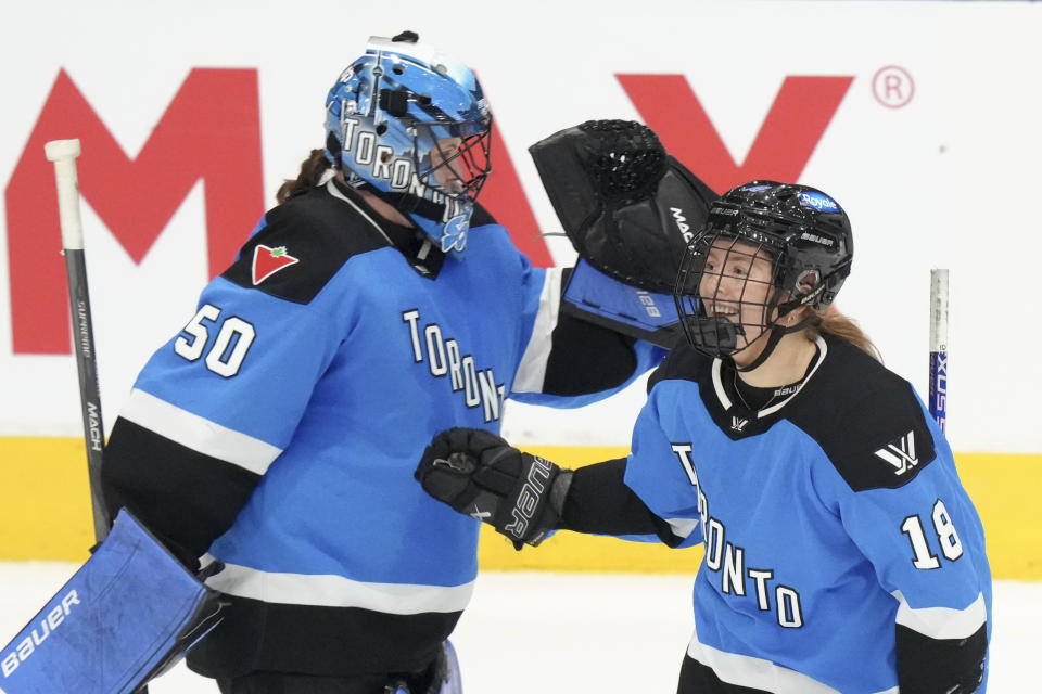 Toronto's Jesse Compher, right, celebrates with goaltender Kristen Campbell after scoring against Minnesota during third-period PWHL hockey playoff action in Toronto, Friday, May 10, 2024. (Chris Young/The Canadian Press via AP)