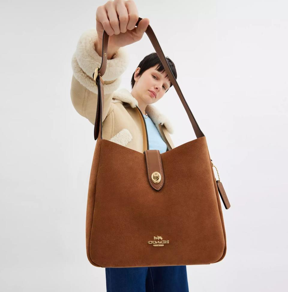 someone holding the Hadley Convertible Crossbody Bag from Coach Outlet