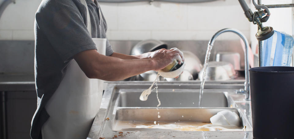 A chef washing dishes.