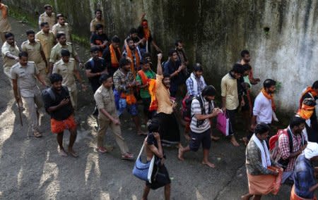 Policemen escort members of the Hindu groups to Pampa base camp, to prevent them from clashing with women of menstrual age entering Sabarimala temple for the first time in centuries, in Pathanamthitta district in the southern state of Kerala, India, October 18, 2018. REUTERS/Sivaram V