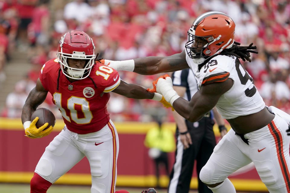 Kansas City Chiefs running back Isiah Pacheco (10) runs past Cleveland Browns defensive end Za'Darius Smith (99) during the first half of an NFL preseason football game Saturday, Aug. 26, 2023, in Kansas City, Mo. (AP Photo/Ed Zurga)