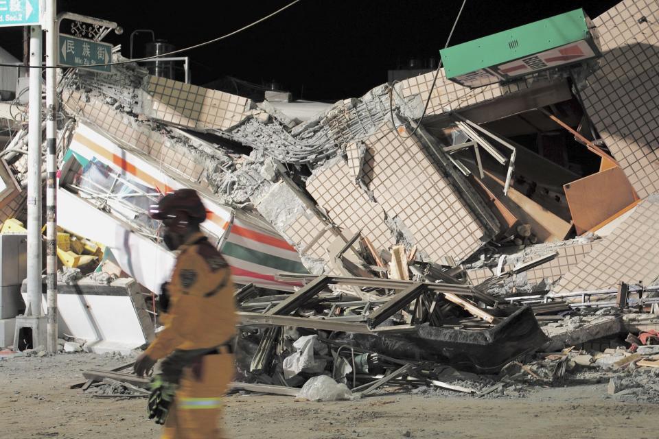 A rescuer walks past a collapsed building after an earthquake at Yuli Township in Hualien county, eastern Taiwan on September 18, 2022