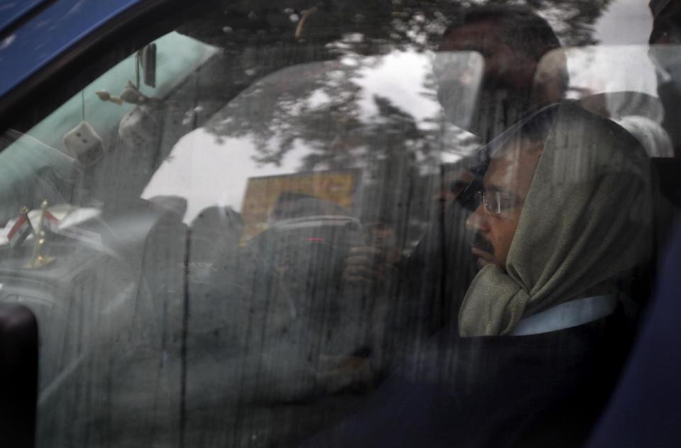 New Delhi Chief Minister Arvind Kejriwal, right, rests inside his Indian-made Maruti WagonR car during a demonstration against the police in New Delhi, India, Tuesday, Jan. 21, 2014. For a decade, Kejriwal has tilted at India's many windmills. He has led protests and hunger strikes against government corruption.But now he is the top official of the Indian capital, an activist suddenly elevated to power. And just a little over a month after his surprise win in city elections, he has launched yet another protest. Even if it's not always clear what he is demanding. (AP Photo/Altaf Qadri)