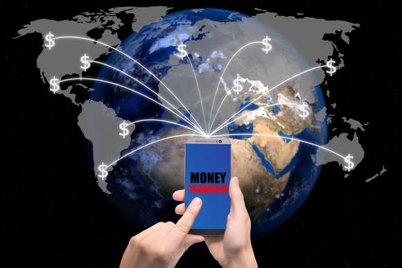 A person using their smartphone to transfer money to various places around the world.