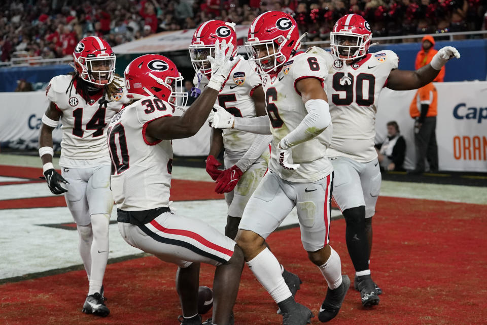 Georgia defensive back Daylen Everette (6) celebrates with linebacker Terrell Foster (30) after intercepting a pass thrown by Florida State quarterback Brock Glenn, not shown, during the second half of Orange Bowl NCAA college football game, Saturday, Dec. 30, 2023, in Miami Gardens, Fla. (AP Photo/Lynne Sladky)