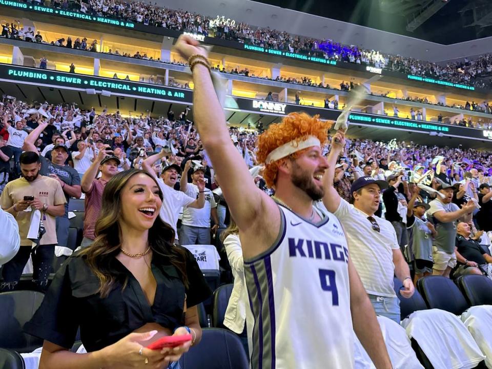 A Sacramento Kings fans and friends Stephanie Mazariegos and Nick Cordano – wearing a Kevin Huerter wig – cheer for their team before Game 7 of the first-round playoff series against the Golden State Warriors at Golden 1 Center on Sunday, April 30, 2023.
