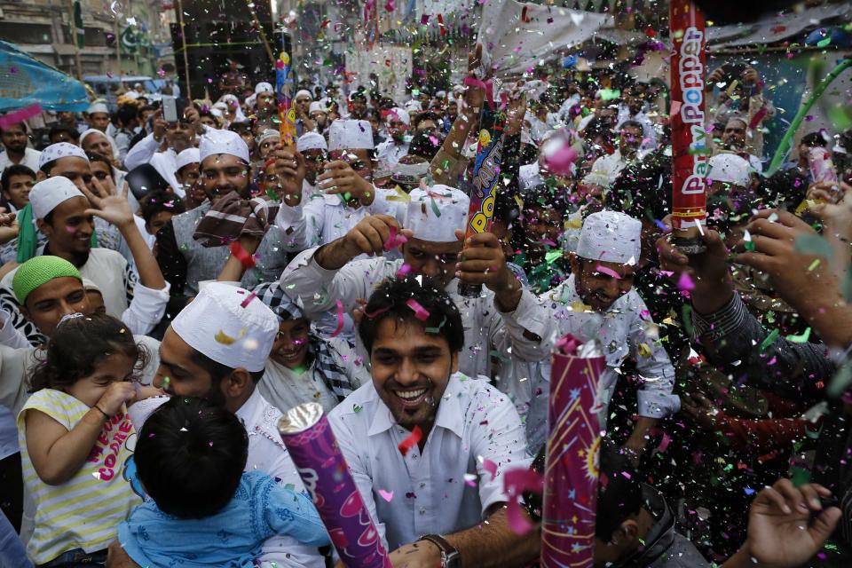 People fire confetti poppers as they participate in a procession to mark Eid-e-Milad-ul-Nabi, or birthday celebrations of Prophet Mohammad in Mumbai